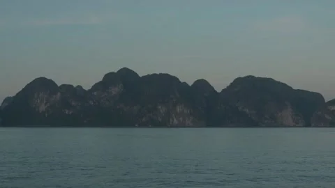 Limestone Cliff Above Calm Waters Of Ha Long Bay At Blue Hour Stock Footage 336724192