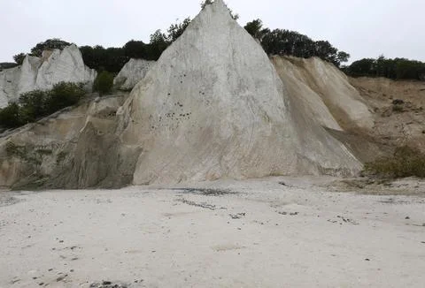 Limestone cliff is eroding due to natural elements, and the trees on top ar.. Stock Photos