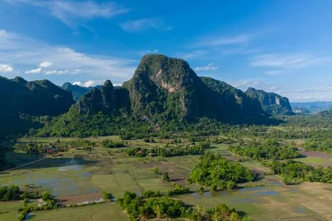 Limestone cliffs above patchwork rice fields Fotos de archivo