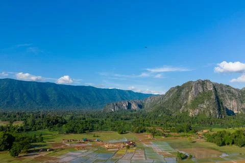 Limestone cliffs and patchwork rice paddies in Laos Fotos de archivo