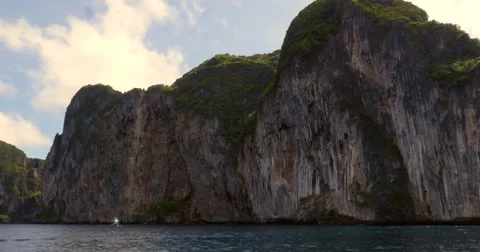 Limestone cliffs with boat off coast of Phuket, Thailand Stock Footage 58977580
