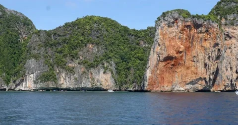 Limestone cliffs with boats off coast of Phuket, Thailand Stock Footage 58975442
