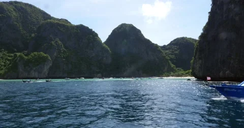 Limestone cliffs with ferry boat off island off coast of Thailand Stock Footage 58975597