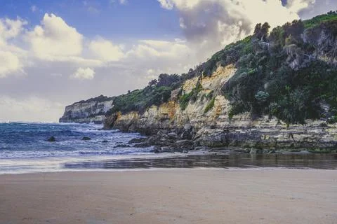 Limestone cliffs over ocean waves in Australia Stock Photos