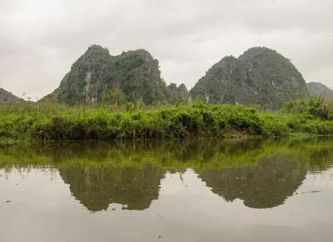 Limestone cliffs reflected in the water. Stock Photos