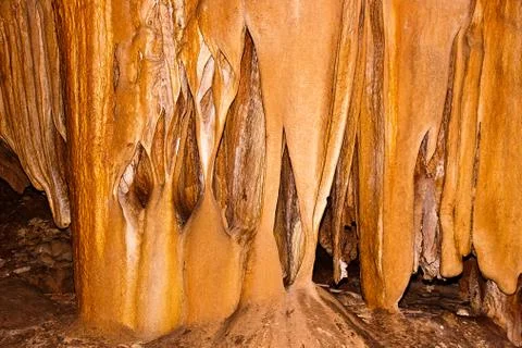 Limestone formations on the wall of an underground cave. Stock Photos