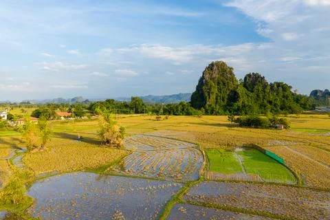 Limestone hill and patchwork rice fields at sunset 스톡 사진