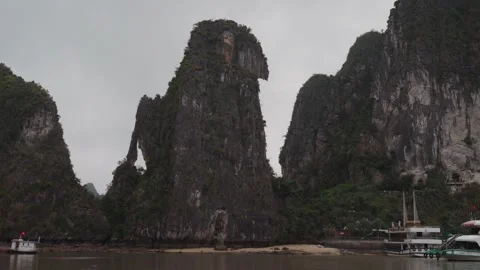 Limestone Karst Cliffs Rising Above Calm Waters in Ha Long Bay, Vietnam Stock Footage 329660146