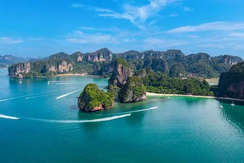 Limestone Karst Cliffs Rising From Turquoise Tropical Waters In Krabi Thail.. Photos