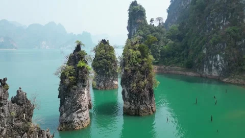 Limestone Karsts Rising from Emerald Lake Water in Khao Sok, Thailand Stock Footage 335580630