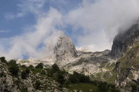 Limestone peak revolved with clouds passing by Stock Photos