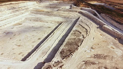 Limestone quarry showing layers of sediment and equipment used in mining Stock Footage 345457119
