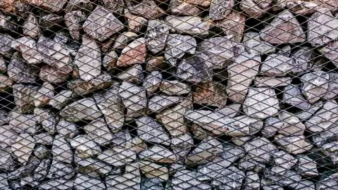 Limestone rock stack background, Rock stack with net barrier, Abstact backgro Stock Photos