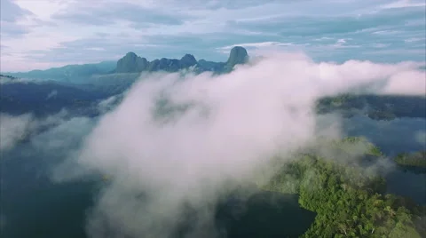 Limestone tower and rain forest seen over white cloud Stockbeeldmateriaal 60735329