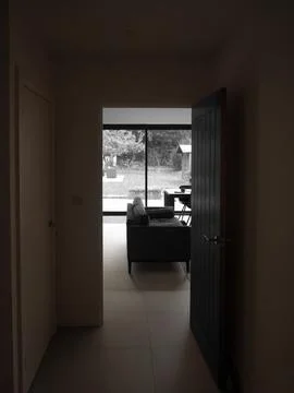 Liminal space of open door into modern room Stock Photos