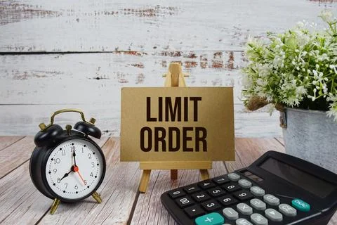 Limit Order text with alarm clock and calculator on wooden background Stock Photos