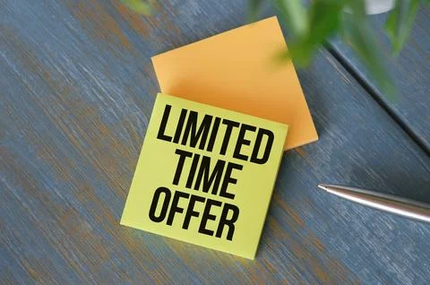 Limited time offer text message on office tablet with office equipment. Stock Photos