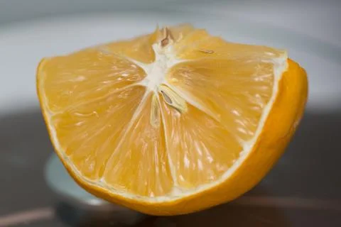 Limon. A slice of lemon with a thin peel lies on the kitchen table Stock Photos
