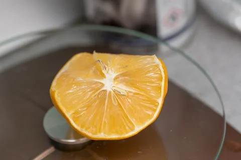 Limon. A slice of lemon with a thin peel lies on the kitchen table Stock Photos
