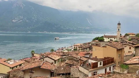 Limone sul Garda, Itlay, old town houses, Garda lake, small plane passing Stock Footage 331455599