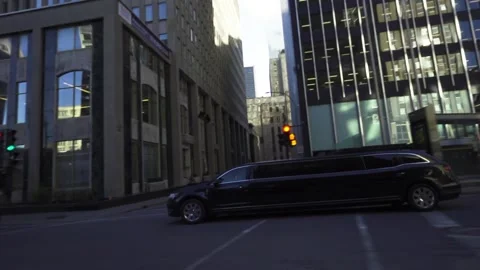 Limosine crosses downtown intersection Stock Footage 167671993