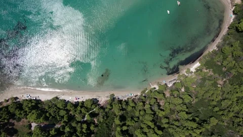 Limpid turquoise water gently lapping against the sandy shore Video stock 315234727