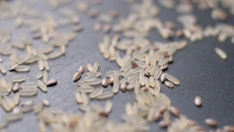 Lin seeds and rice falling slow motion Видео 99092076
