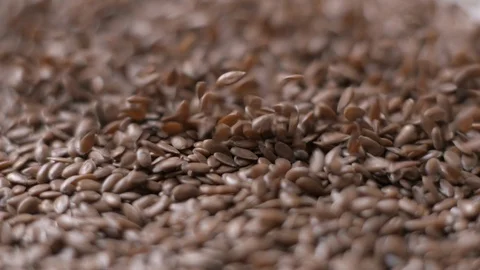Lin seeds and rice falling slow motion Stock Footage 99092276