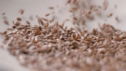 Lin seeds and rice falling slow motion Stock-Footage 99092296