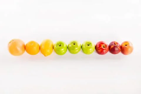 Line of apples in different colors on a white background Stock Photos