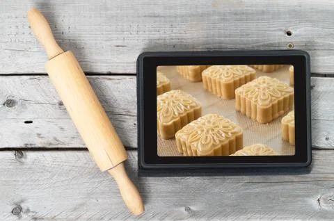 On-line bakery concept with a touch screen tablet and rolling pin Stock Photos