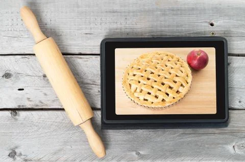 On-line bakery concept with a touch screen tablet and rolling pin Stock Photos