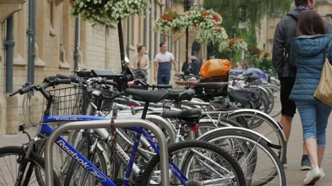 A line of bikes and cycles parked on Broad Street, Oxford Video stock 162338305