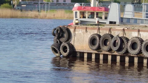 Line of black tires hanging on the side of the port Stock Footage 90556960