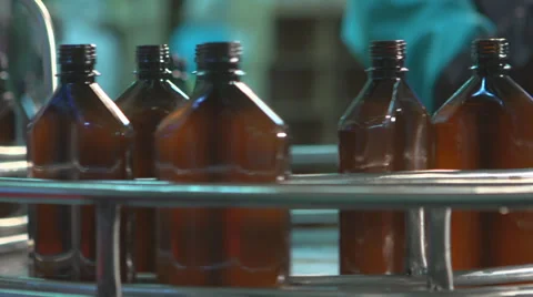Line for bottling liquid products in plastic bottles. Plastic crates on conveyor Stock Footage 34276685