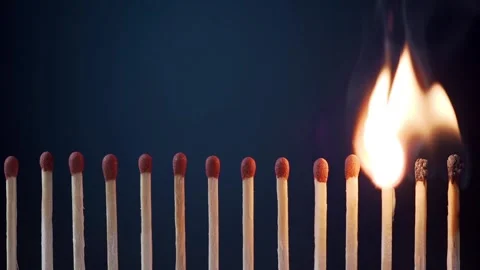Line of burning matches on the dark background. Close up shoot Stock Footage 136035710