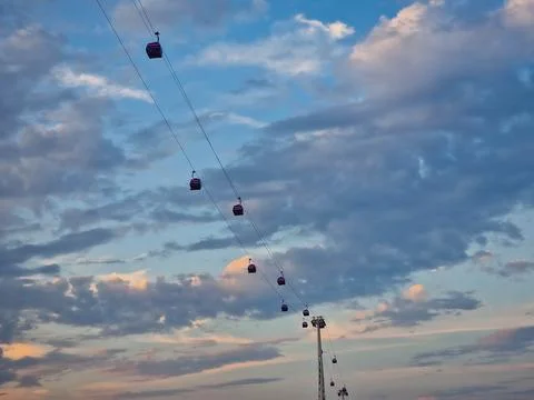 Line of Cable Car Gondolas in the Sky at Sunset Stock Photos