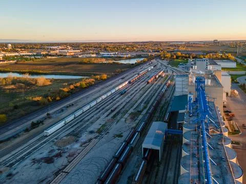Line of cargo trains at nearly empty marshaling yard Stock Photos