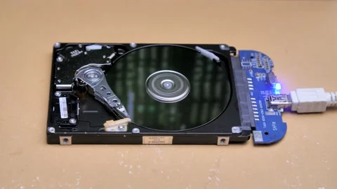 Line of code in the reflection on the HDD. Work of open hard drive inside. Video stock 132653233