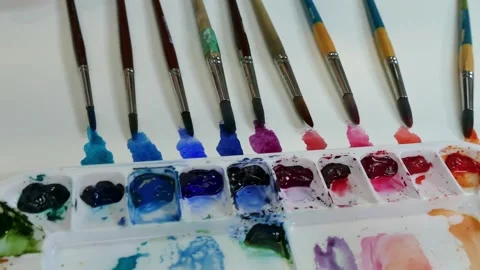 Line of colored brushes, hand paints and puts one down Stock Footage 313955909
