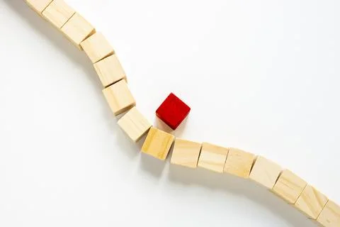 A line of cubes bends to overcome an obstacle. Moving towards goals and solving Stock Photos