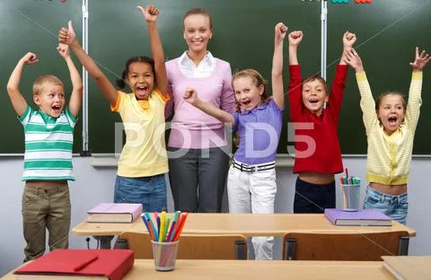 Line of cute schoolchildren raising arms with their teacher in the middle Stock Photos