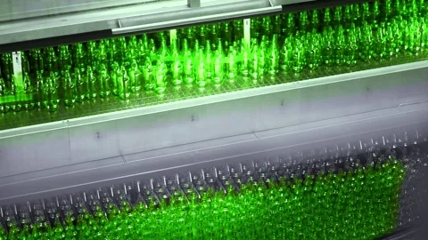 Line for filling beer in a brewery. Empty green glass bottles moving on a Stock-Footage 155012548