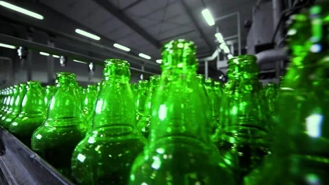 Line for filling beer in a brewery. Empty green glass bottles moving on a Stock-Footage 155012582