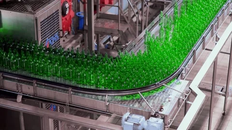 Line for filling beer in a brewery. Empty green glass bottles moving on a Stock-Footage 155012609