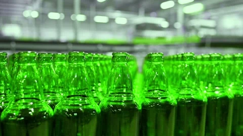 Line for filling beer in a brewery. Empty green glass bottles moving on a Stock-Footage 155012642