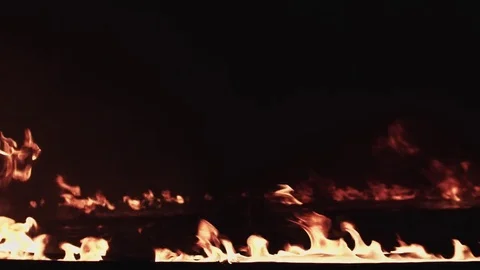 A line of fire burning in the dark place in slow motion Stock Footage 77069284