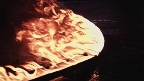 A line of fire burning in the dark place in slow motion Stock Footage 77069308