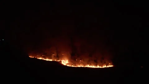 Line of fire cuts the hill in two in the night Stock Footage 340389097