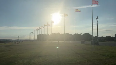 A line of flags fluttering during sunset Stock Footage 288011734